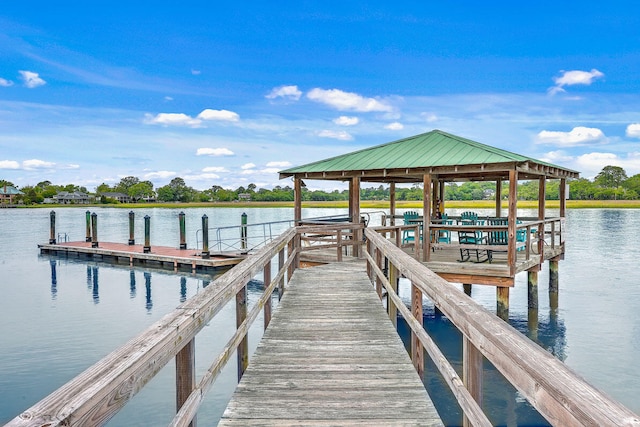 view of dock with a gazebo and a water view