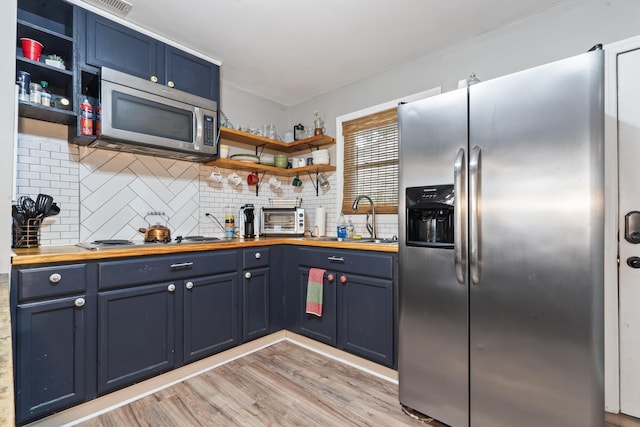 4619 Jenkins Ave Unit 1-4, North Charleston, SC 29405 - kitchen featuring appliances with stainless steel finishes, butcher block counters, open shelves, a sink, and blue cabinets