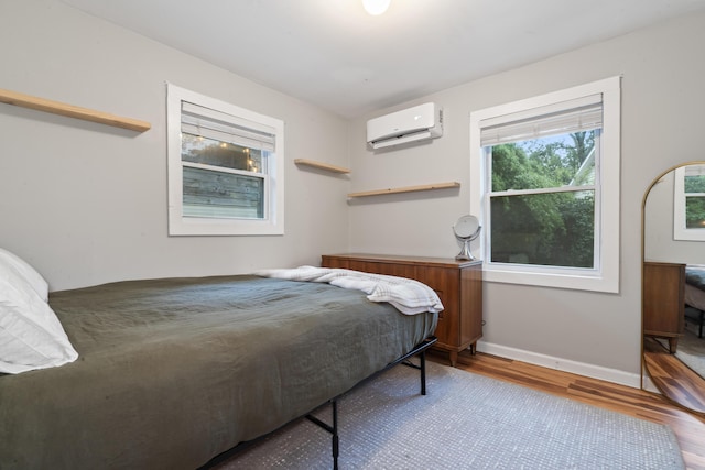 4619 Jenkins Ave Unit 1-4, North Charleston, SC 29405 - bedroom with wood finished floors, a wall mounted AC, and baseboards