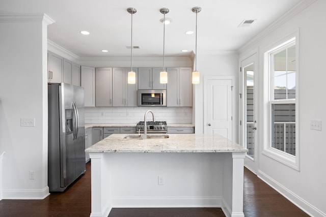 kitchen featuring sink, gray cabinets, appliances with stainless steel finishes, light stone countertops, and decorative light fixtures