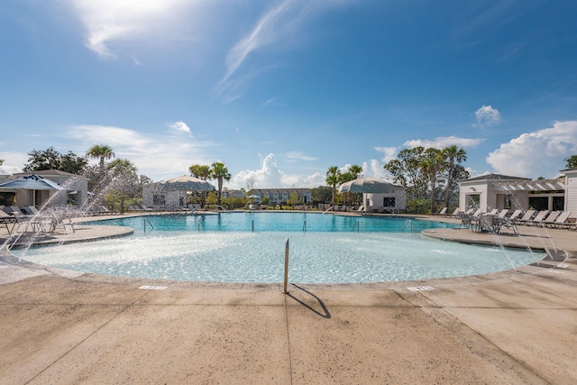 view of pool with a patio area and pool water feature