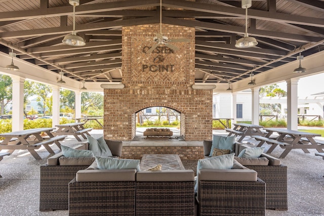 view of patio featuring a gazebo and an outdoor living space with a fireplace