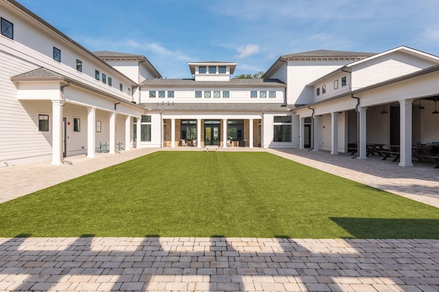 back of house featuring a yard