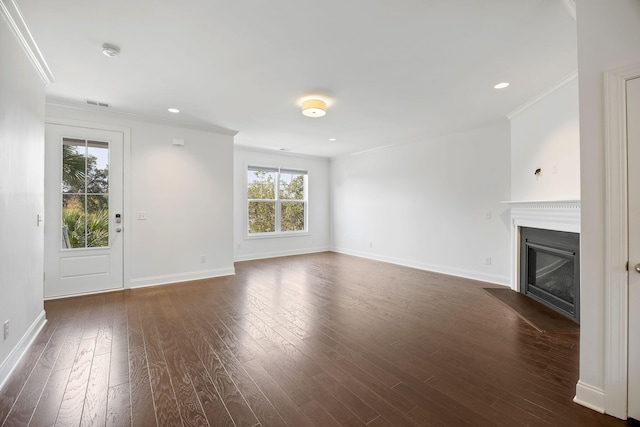 unfurnished living room featuring dark wood-type flooring and ornamental molding