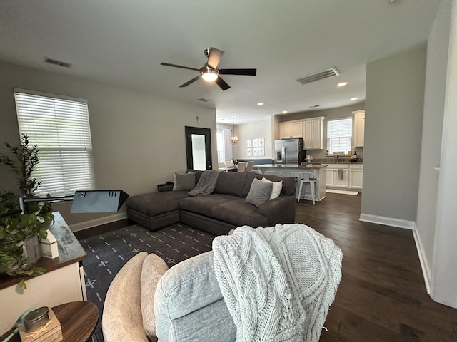 living area featuring baseboards, dark wood-style flooring, ceiling fan, and recessed lighting