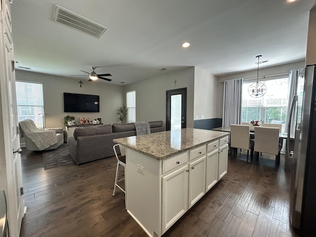 kitchen featuring healthy amount of natural light, dark wood finished floors, stainless steel fridge with ice dispenser, and recessed lighting