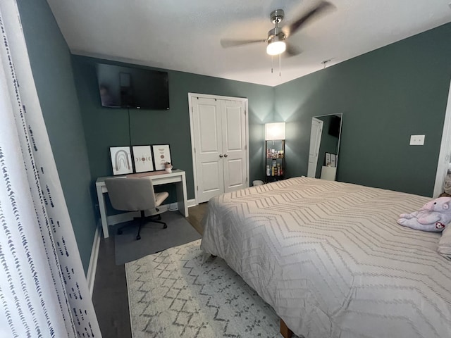 bedroom with a closet, a ceiling fan, and baseboards