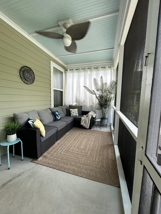 sunroom featuring a ceiling fan and an outdoor hangout area