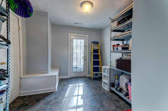 mudroom with a textured ceiling