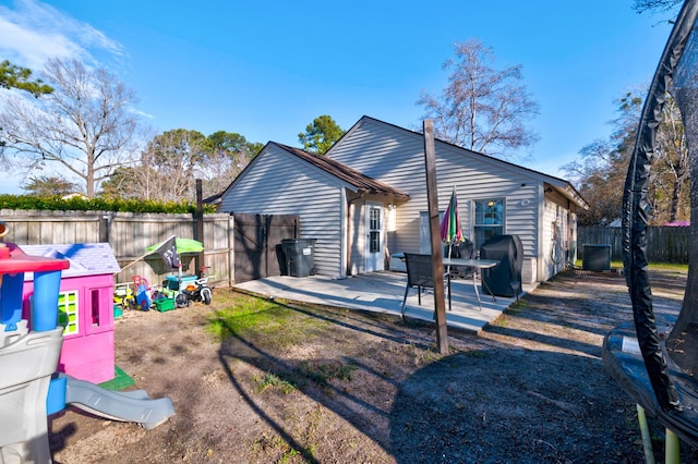 rear view of house featuring central AC and a patio