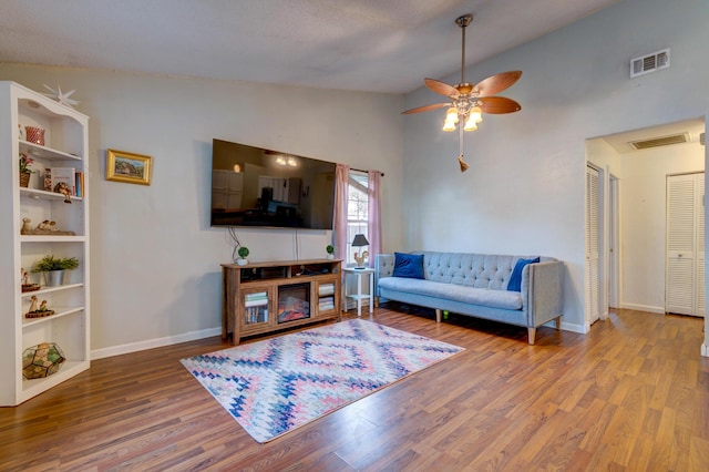 living room with vaulted ceiling, ceiling fan, and hardwood / wood-style floors