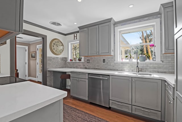 kitchen with gray cabinets, ornamental molding, sink, and stainless steel dishwasher