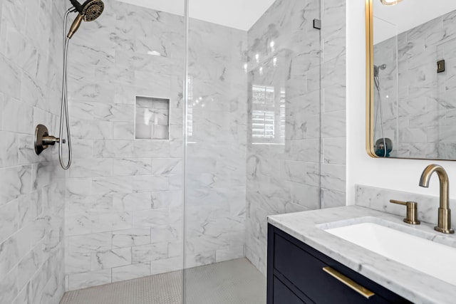 bathroom featuring vanity and tiled shower