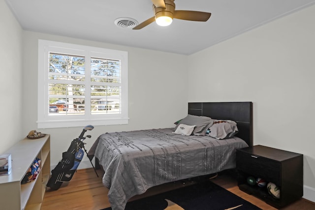 bedroom featuring hardwood / wood-style flooring and ceiling fan