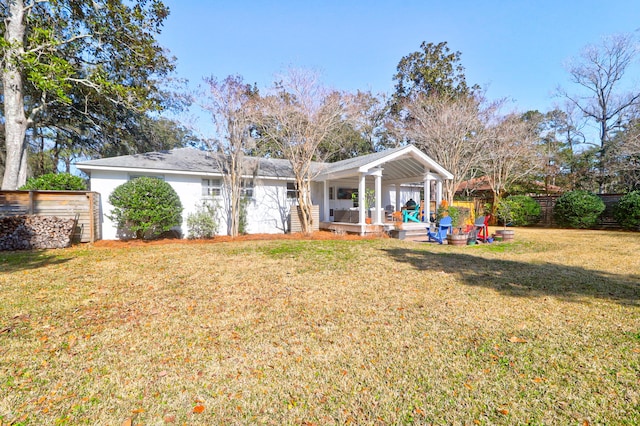 rear view of property with a lawn