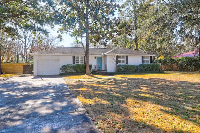 ranch-style house with a garage and a front yard