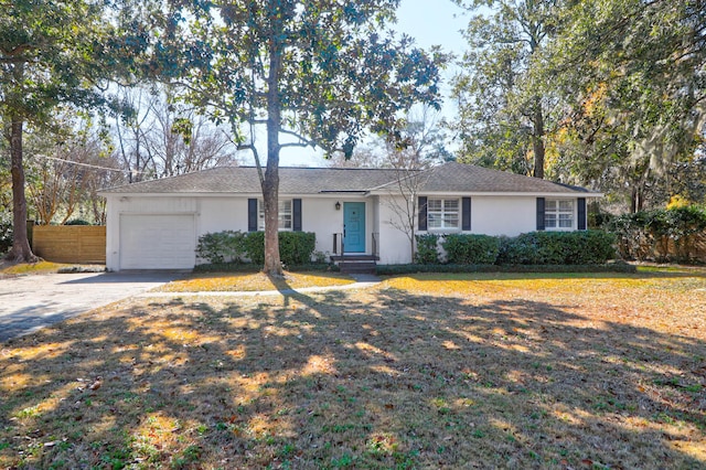 single story home featuring a garage and a front yard