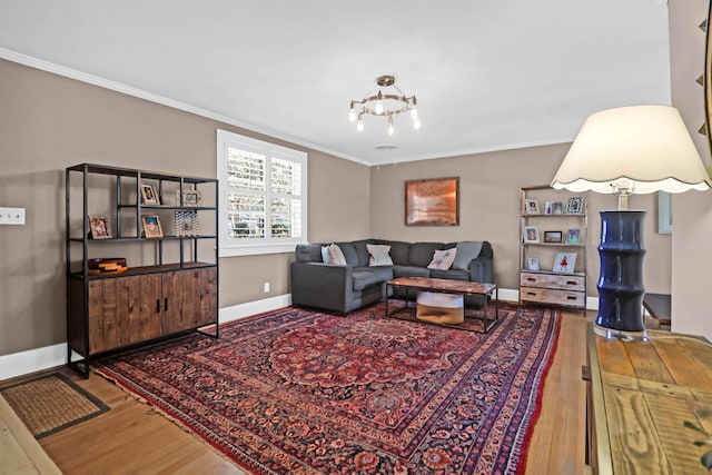 living room with crown molding, a notable chandelier, and hardwood / wood-style flooring