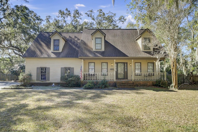 cape cod home with a front yard, covered porch, and fence