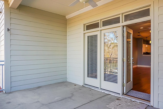 entrance to property featuring ceiling fan and a patio area