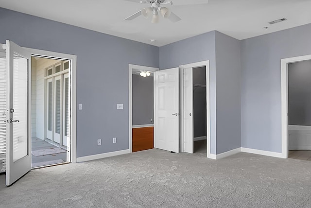 unfurnished bedroom featuring light carpet and ceiling fan