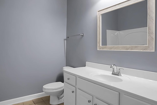 bathroom with vanity, walk in shower, tile patterned floors, and toilet