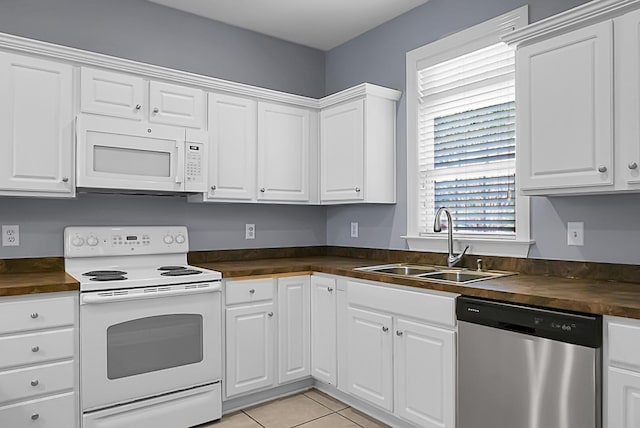 kitchen with white cabinetry, white appliances, and wooden counters