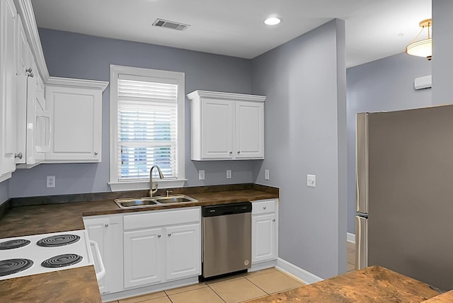 kitchen with white cabinetry, appliances with stainless steel finishes, light tile patterned flooring, and sink