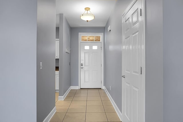 doorway with light tile patterned floors