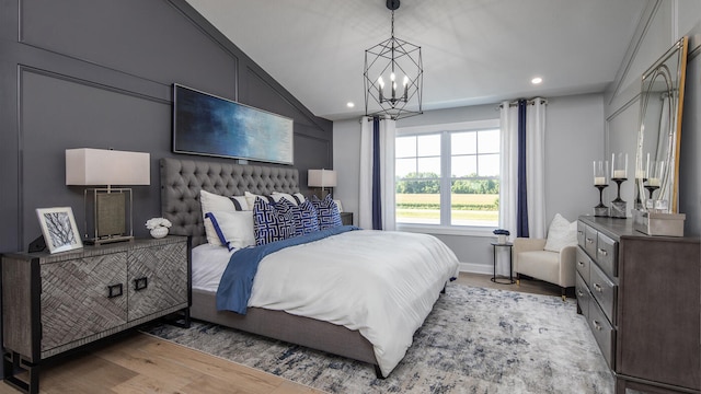 bedroom featuring lofted ceiling, recessed lighting, baseboards, light wood-type flooring, and an inviting chandelier