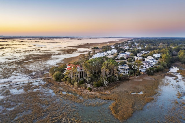 aerial view at dusk with a water view