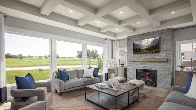 living room with a rural view, coffered ceiling, a fireplace, wood finished floors, and beamed ceiling