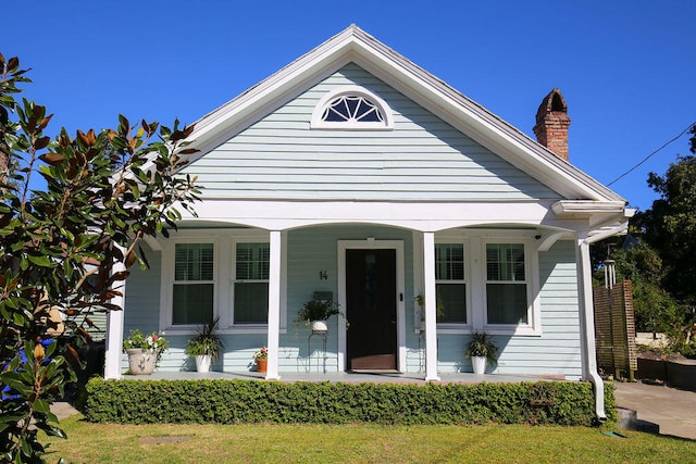 view of front of home with a front lawn and a porch