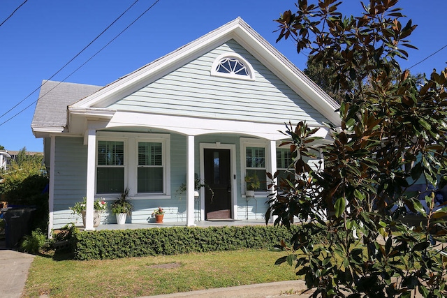 bungalow-style house with a porch and a front yard