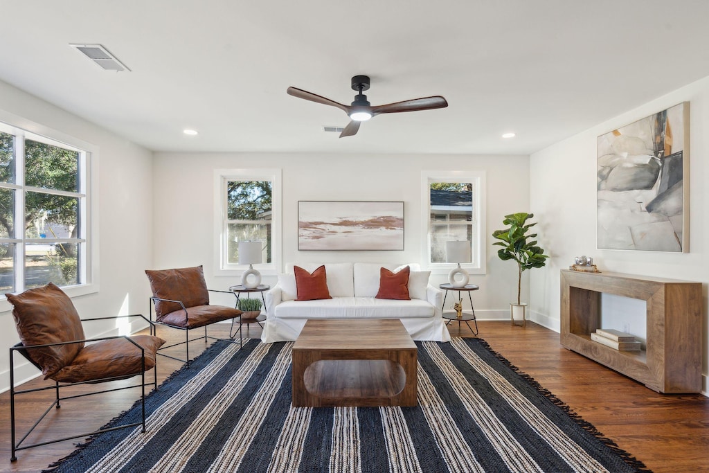 living area featuring hardwood / wood-style flooring and ceiling fan