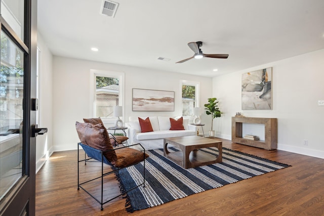 living room with ceiling fan, dark hardwood / wood-style flooring, and plenty of natural light