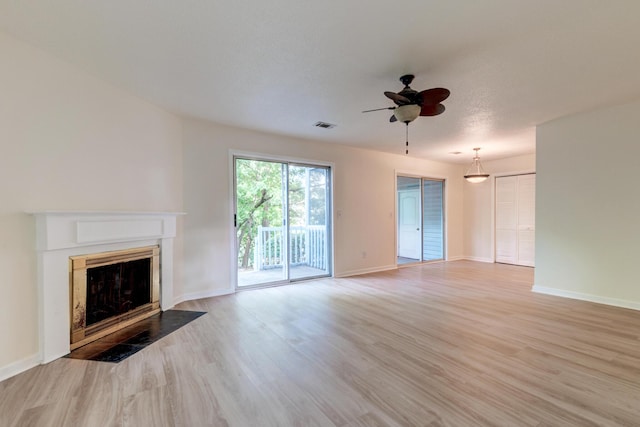 6275 Rolling Fork Rd Unit 401, North Charleston, SC 29406 - unfurnished living room with a ceiling fan, a fireplace with flush hearth, and light wood finished floors
