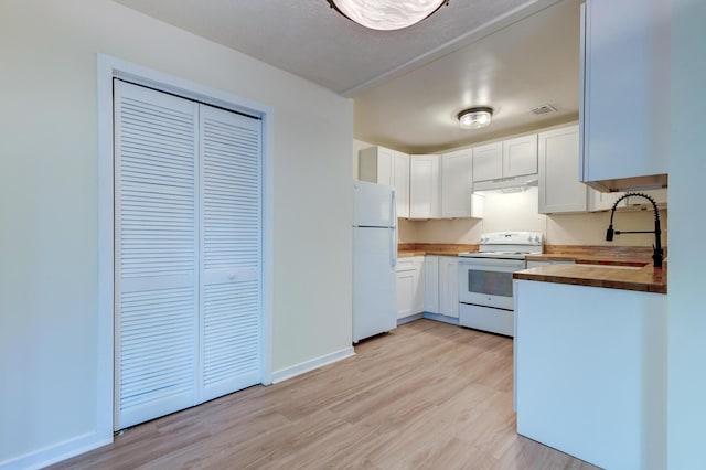 6275 Rolling Fork Rd Unit 401, North Charleston, SC 29406 - kitchen with butcher block counters, white appliances, light wood-style flooring, white cabinets, and under cabinet range hood