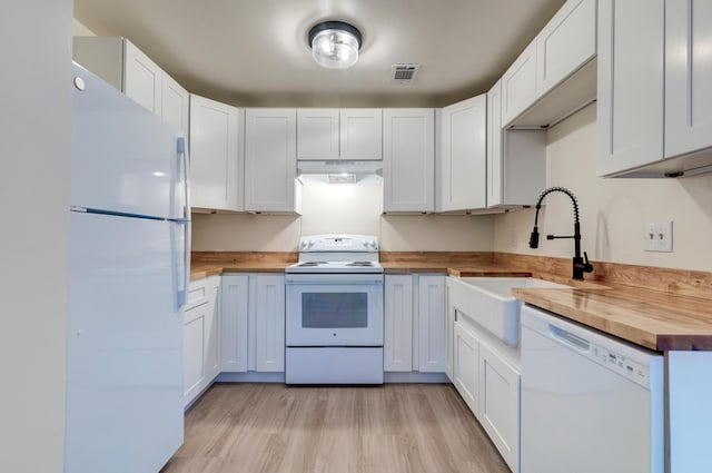 6275 Rolling Fork Rd Unit 401, North Charleston, SC 29406 - kitchen with white appliances, butcher block countertops, under cabinet range hood, light wood-style flooring, and white cabinets