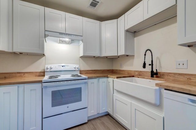 6275 Rolling Fork Rd Unit 401, North Charleston, SC 29406 - kitchen with wooden counters, white appliances, under cabinet range hood, and white cabinetry
