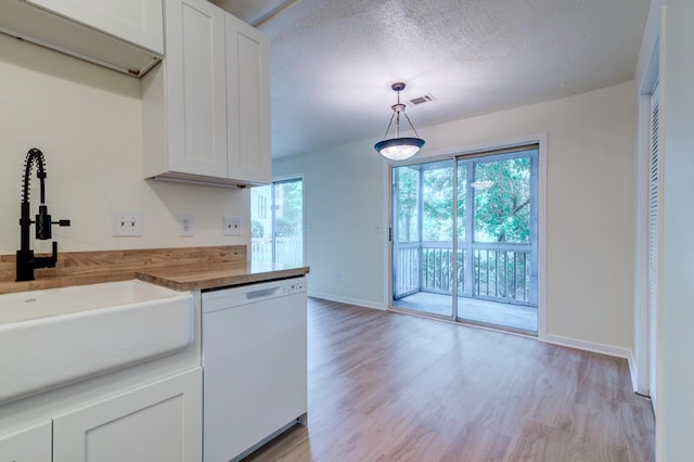6275 Rolling Fork Rd Unit 401, North Charleston, SC 29406 - kitchen with dishwasher, healthy amount of natural light, light wood finished floors, white cabinetry, and a textured ceiling