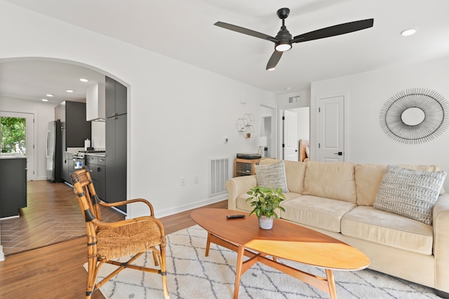 living room featuring ceiling fan and light hardwood / wood-style flooring