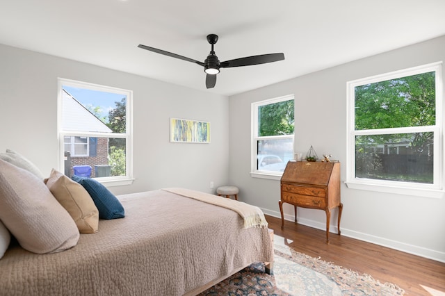 bedroom with ceiling fan and wood-type flooring