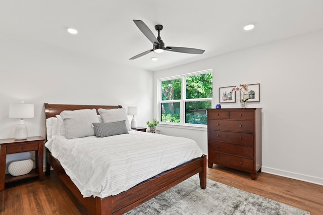 bedroom with dark hardwood / wood-style floors and ceiling fan