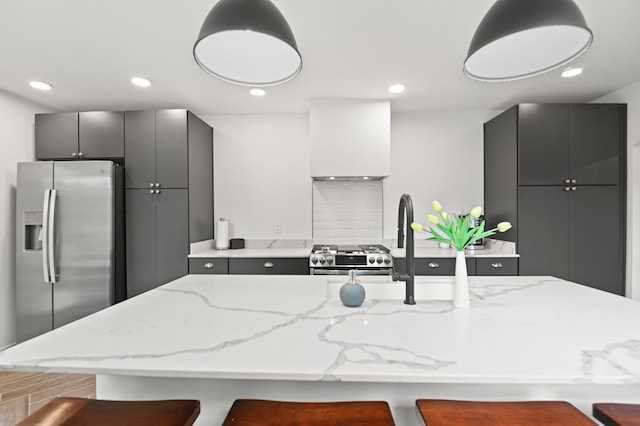 kitchen with a kitchen breakfast bar, stainless steel appliances, custom range hood, and an island with sink