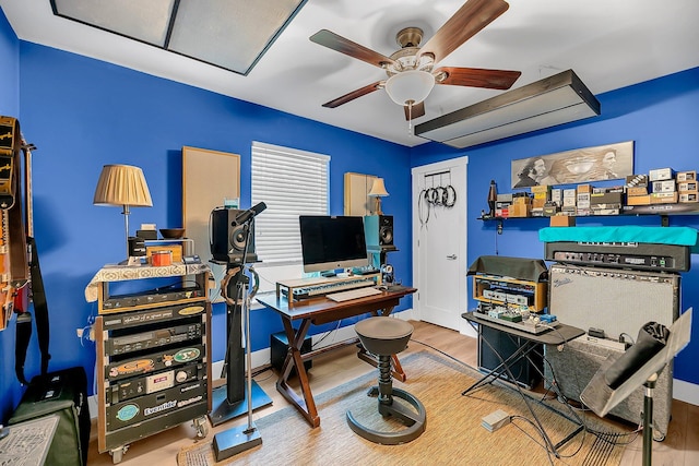 office space with a ceiling fan and wood finished floors