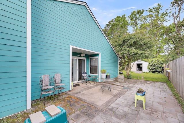 view of patio / terrace with a storage shed, an outdoor structure, and a fenced backyard