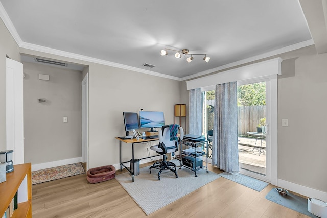 office area with crown molding, wood finished floors, and visible vents