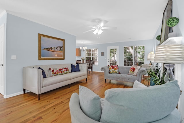 1394 Center Lake Dr, Mount Pleasant, SC 29464 - living room with light wood-type flooring, a chandelier, ceiling fan, ornamental molding, and baseboards