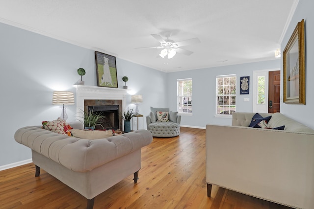 1394 Center Lake Dr, Mount Pleasant, SC 29464 - living area featuring light wood-style flooring, a ceiling fan, a fireplace, baseboards, and crown molding